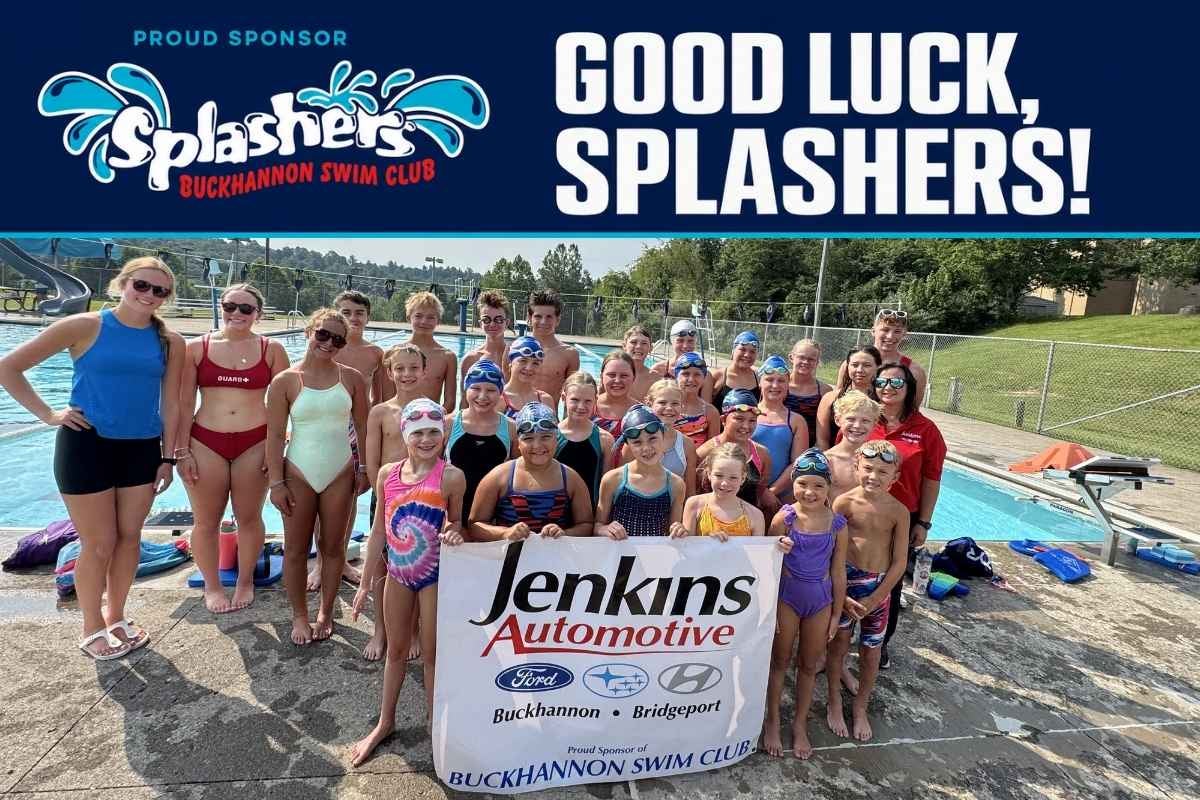Buckhannon Splashers holding a Jenkins Automotive sponsorship banner at Upshur County Recreational Park.